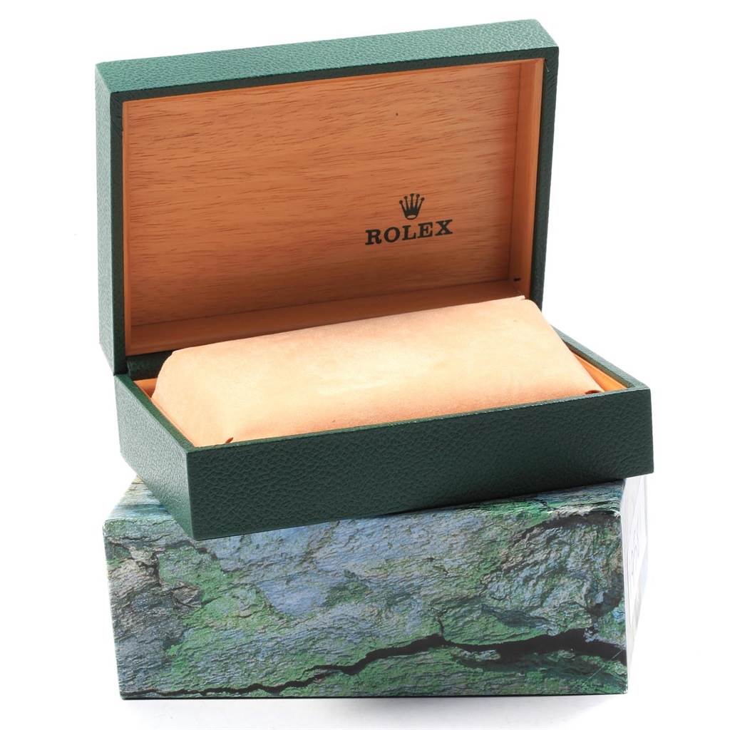 An open green box for a Rolex Datejust 16233 Men's Steel and Gold (two tone) White Dial 16233 Men's Steel and Gold (two tone) White Dial is shown from the front angle, revealing the interior with a pillow for the watch.