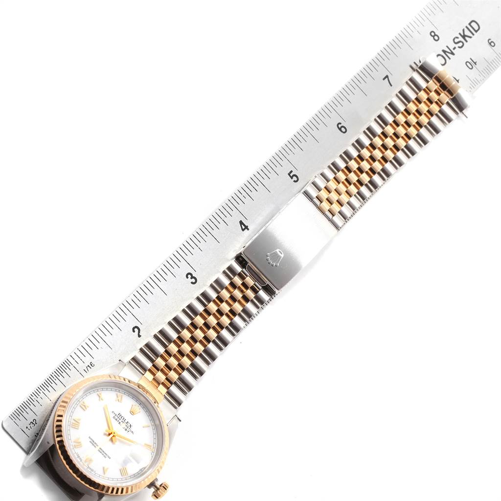 The image shows a Rolex Datejust 16233 Men's Steel and Gold (two tone) White Dial 16233 Men's Steel and Gold (two tone) White Dial watch laid flat, with a ruler measuring the length of its bracelet.