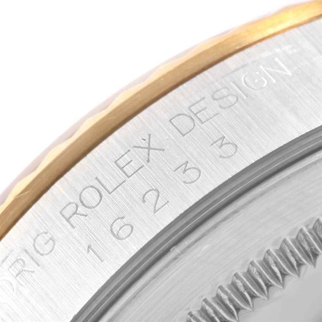 This close-up angle of the Rolex Datejust 16233 Men's Steel and Gold (two tone) White Dial 16233 Men's Steel and Gold (two tone) White Dial watch shows the engraved model details on the side of the case and a partial view of the bezel.