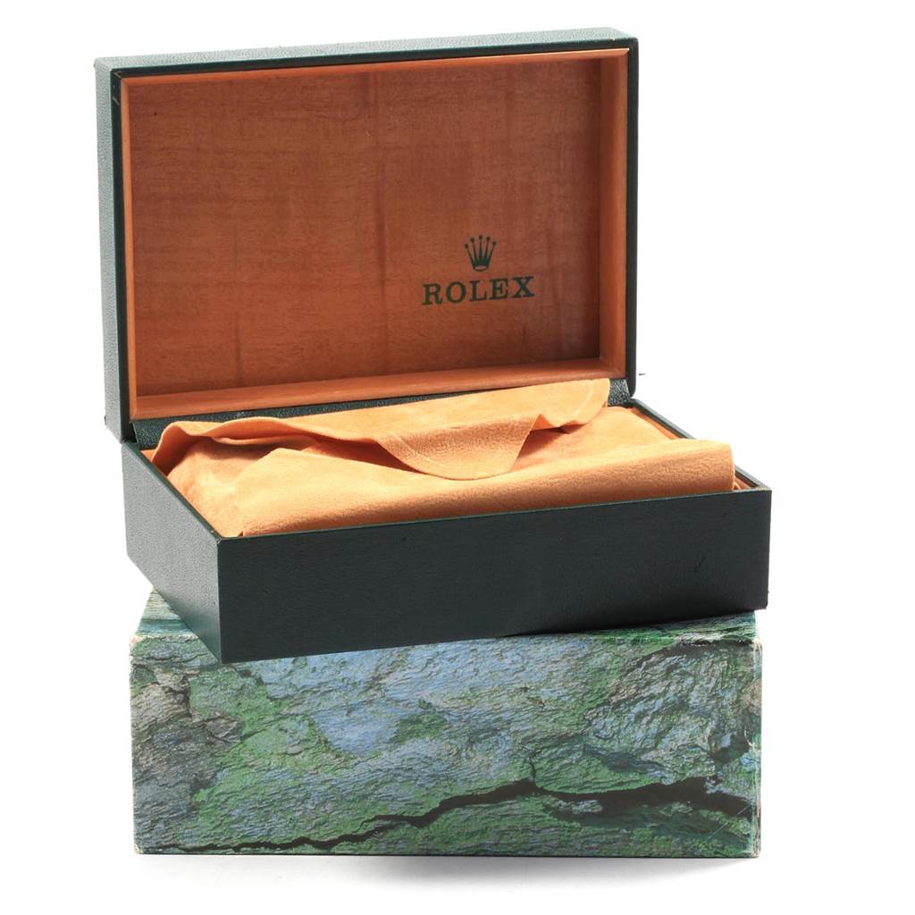 The image shows an open Rolex Datejust 16233 Men's Steel and Gold (two tone) White Dial 16233 Men's Steel and Gold (two tone) White Dial watch box on top of a textured, green outer box.