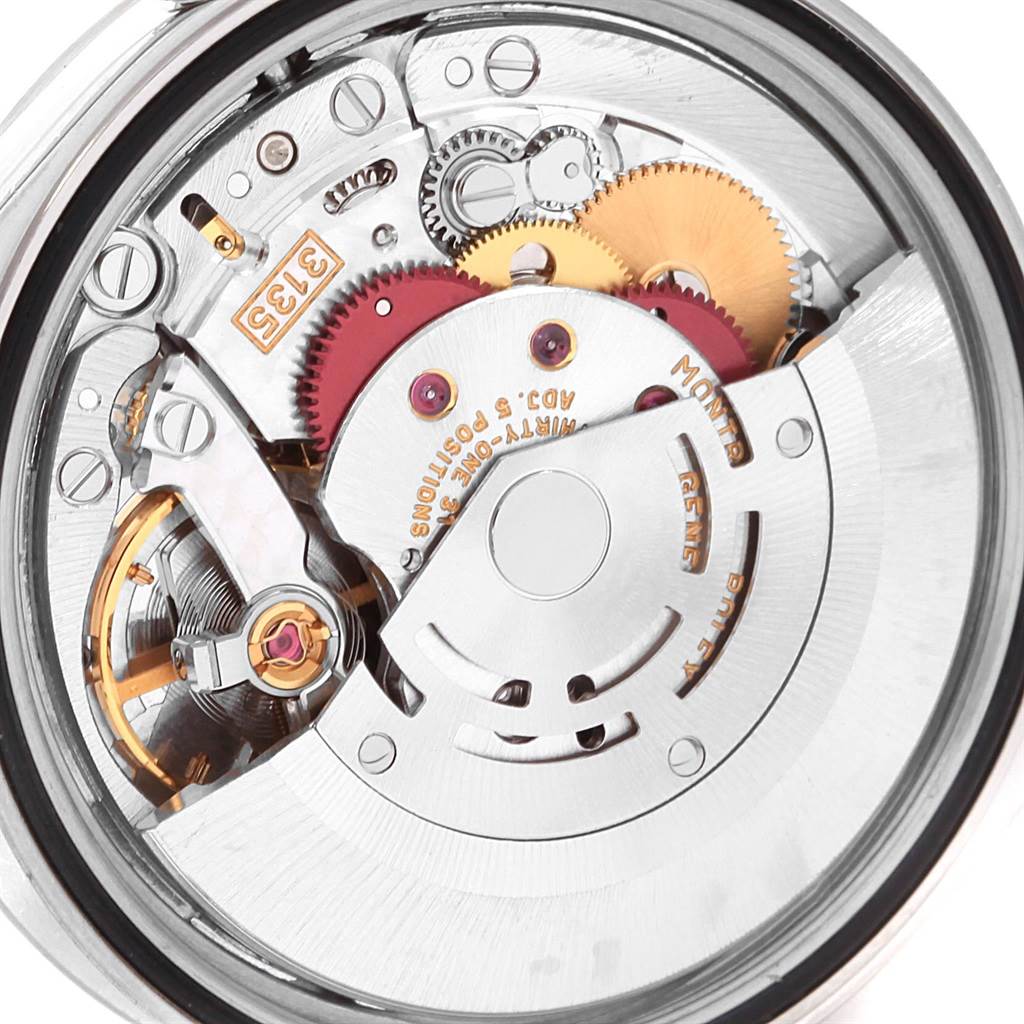 The image shows the intricate inner mechanism of a Rolex Datejust 16200 Men's Stainless Steel Silver Dial 16200 Men's Stainless Steel Silver Dial watch, highlighting gears and movement components.
