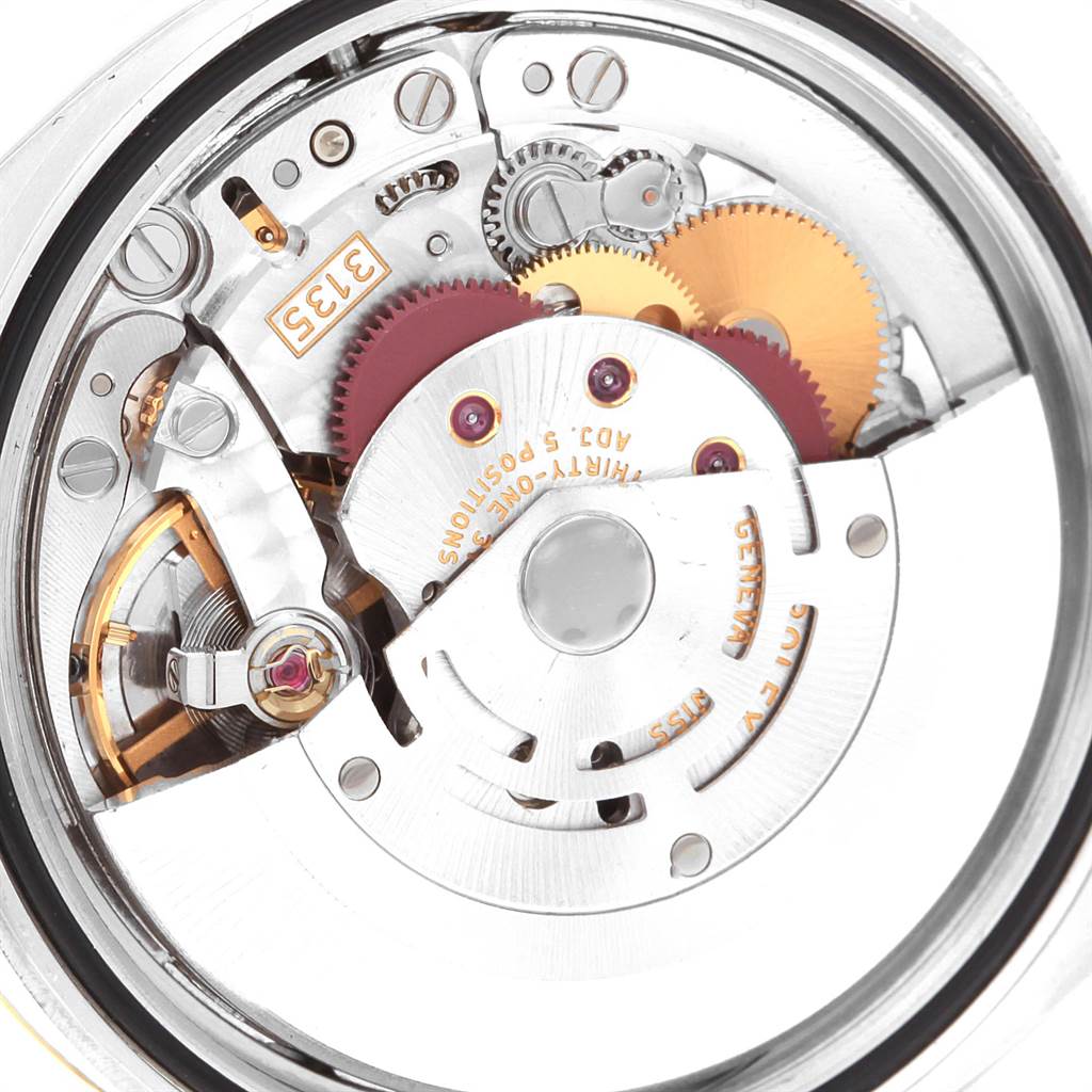 This image shows the internal mechanism of a Rolex Datejust 116233 Men's Stainless Steel Champagne Dial 116233 Men's Stainless Steel Champagne Dial watch, highlighting gears and the rotor in a close-up view.