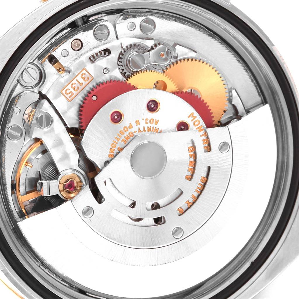 This close-up image shows the intricate inner mechanics of a Rolex Datejust 116233 Men's Stainless Steel White Dial 116233 Men's Stainless Steel White Dial watch, highlighting gears and movement components.