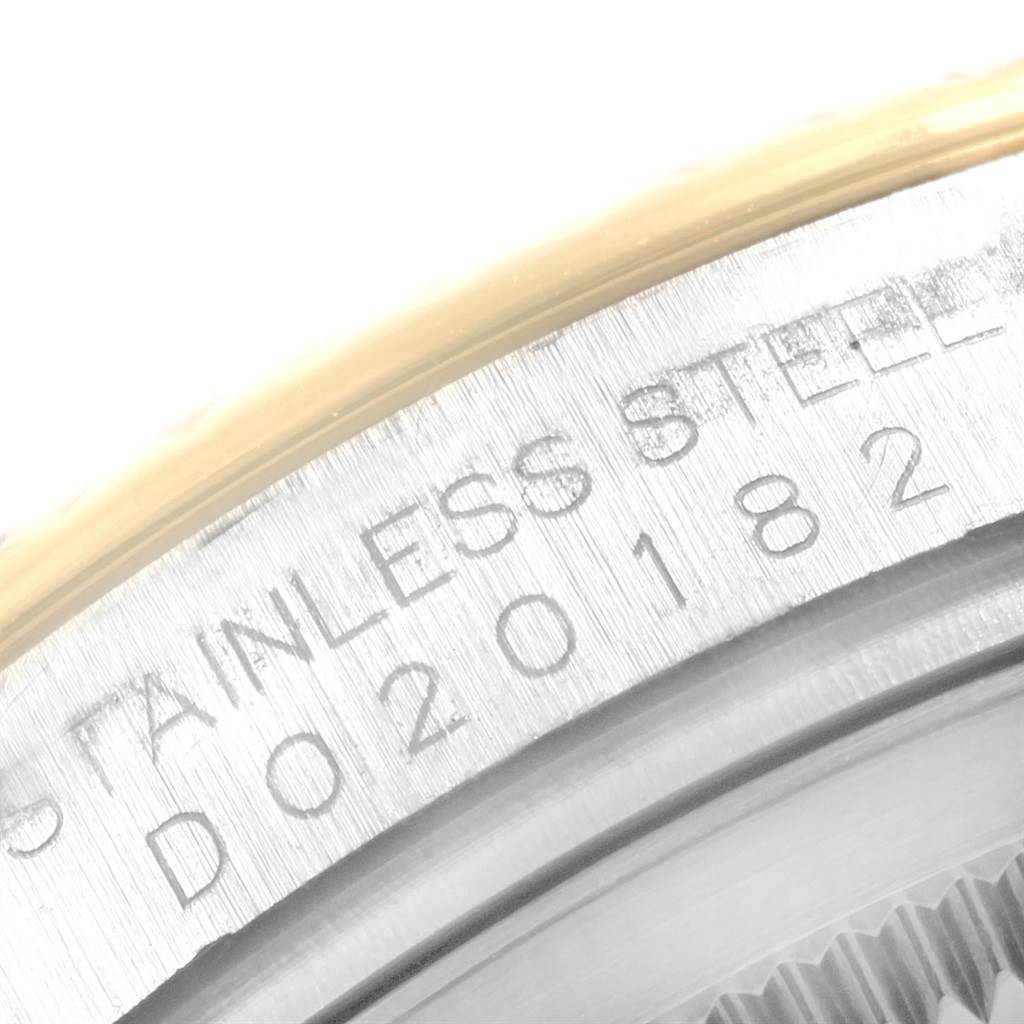 This close-up image shows the outer edge of the stainless steel bezel of a Rolex Datejust 116233 Men's Stainless Steel White Dial 116233 Men's Stainless Steel White Dial watch.