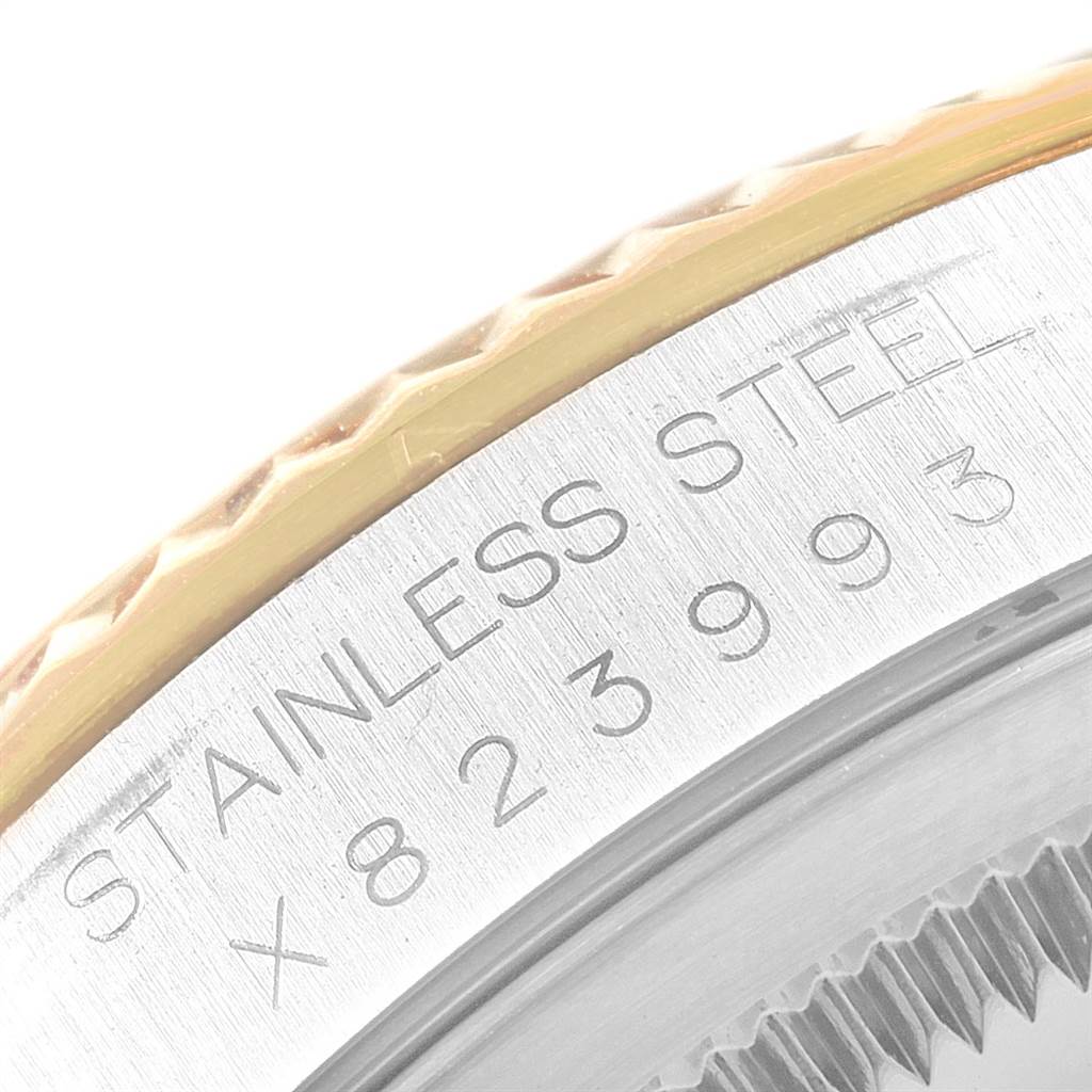 This close-up image shows the engraved serial number and part of the bezel on the Rolex Datejust 16233 Men's Steel and Gold (two tone) Champagne Dial 16233 Men's Steel and Gold (two tone) Champagne Dial watch.