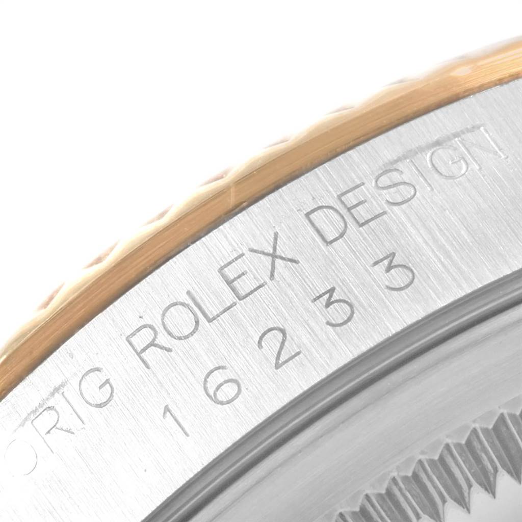 Close-up shot showing the bezel and engraved case side of a Rolex Datejust 16233 Men's Steel and Gold (two tone) Champagne Dial 16233 Men's Steel and Gold (two tone) Champagne Dial model.
