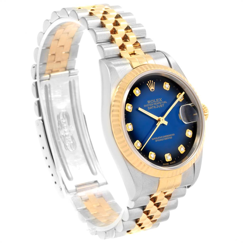 This image shows a Rolex Datejust 16233 Men's Steel and Gold (two tone) Blue Dial 16233 Men's Steel and Gold (two tone) Blue Dial watch from a left-side angle, highlighting its blue dial, two-tone bracelet, and gold bezel.