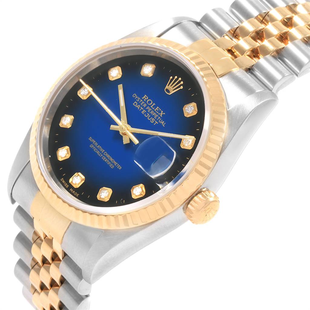 The image shows a Rolex Datejust 16233 Men's Steel and Gold (two tone) Blue Dial 16233 Men's Steel and Gold (two tone) Blue Dial watch from a slight side angle, displaying the blue dial, gold bezel, and two-tone bracelet.