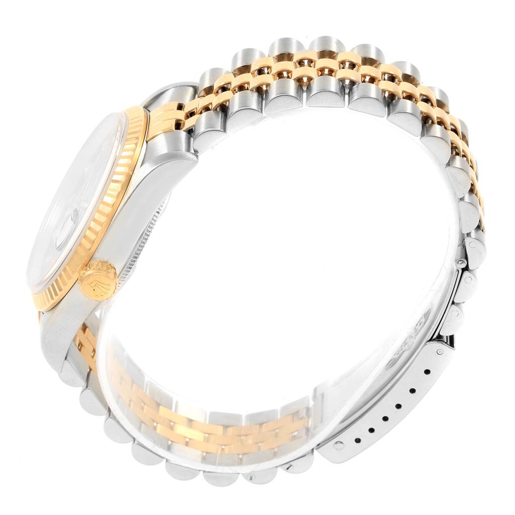 The image shows a side view of a Rolex Datejust 16233 Men's Steel and Gold (two tone) Blue Dial 16233 Men's Steel and Gold (two tone) Blue Dial watch, highlighting the crown, fluted bezel, and two-tone bracelet.