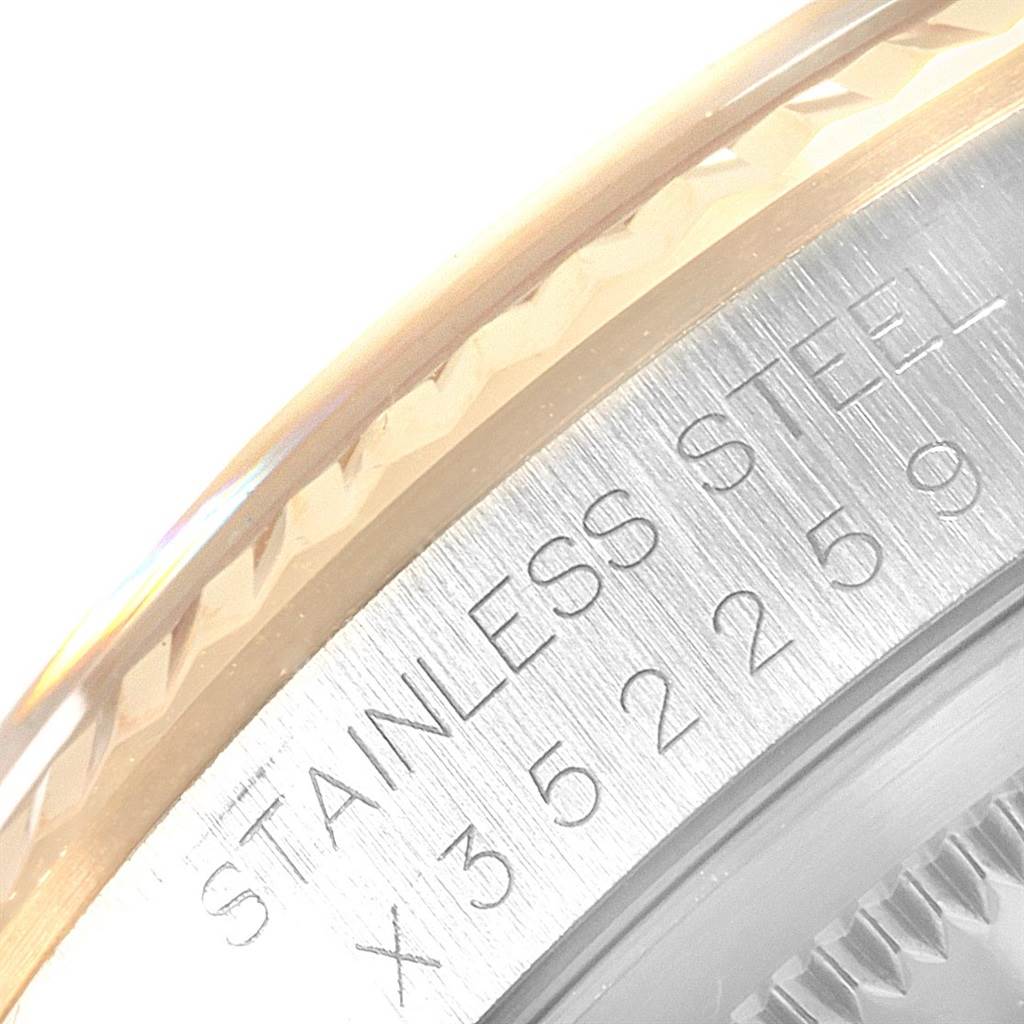 The image shows a close-up of the bezel and case side of a Rolex Datejust 16233 Men's Steel and Gold (two tone) Champagne Dial 16233 Men's Steel and Gold (two tone) Champagne Dial watch, displaying the "STAINLESS STEEL" engraving and serial number.