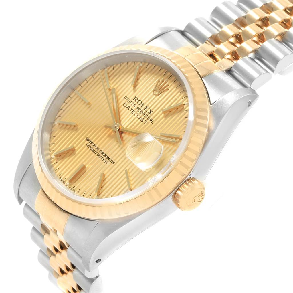 The image shows a side angle view of a Rolex Datejust 16233 Men's Steel and Gold (two tone) Champagne Dial 16233 Men's Steel and Gold (two tone) Champagne Dial watch highlighting its golden dial, bezel, crown, and two-tone bracelet.