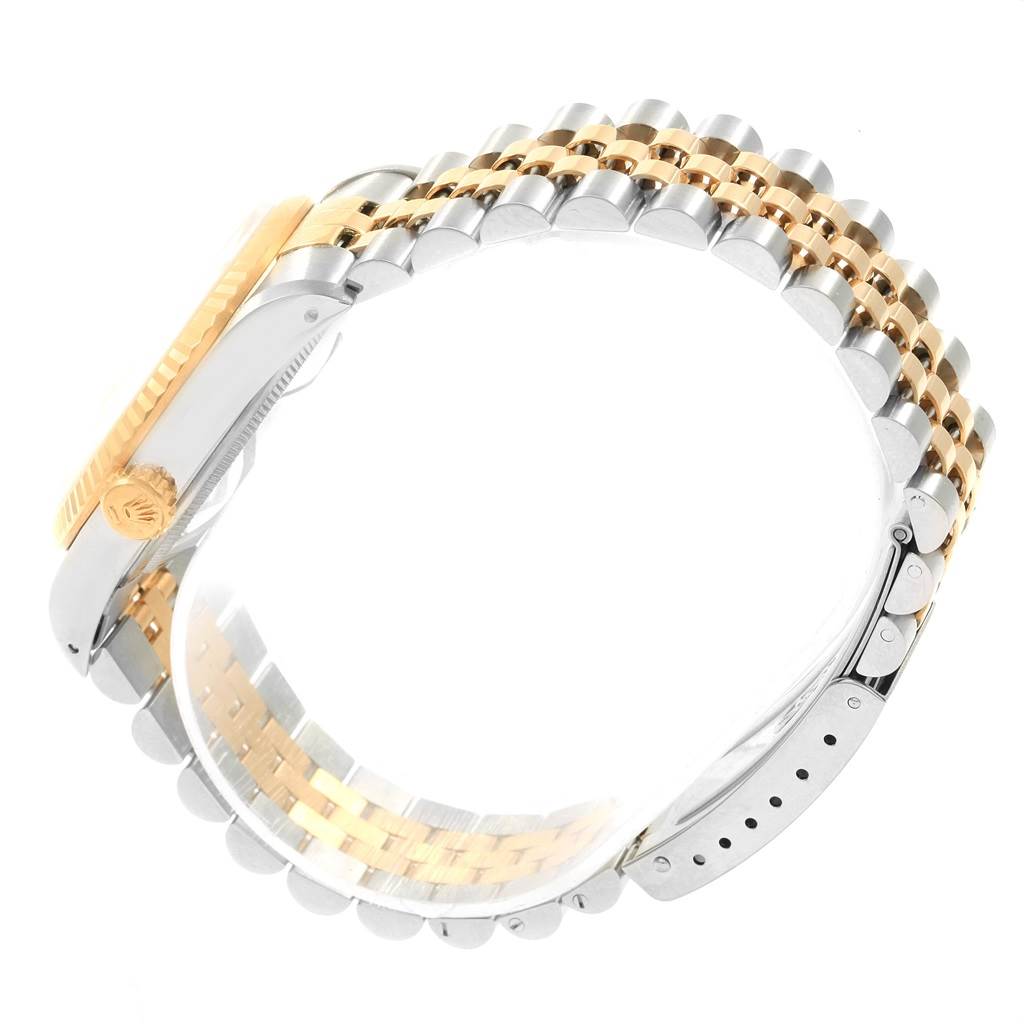 This image shows the side view of a Rolex Datejust 16233 Men's Steel and Gold (two tone) Champagne Dial 16233 Men's Steel and Gold (two tone) Champagne Dial watch, highlighting its two-tone bracelet and crown.