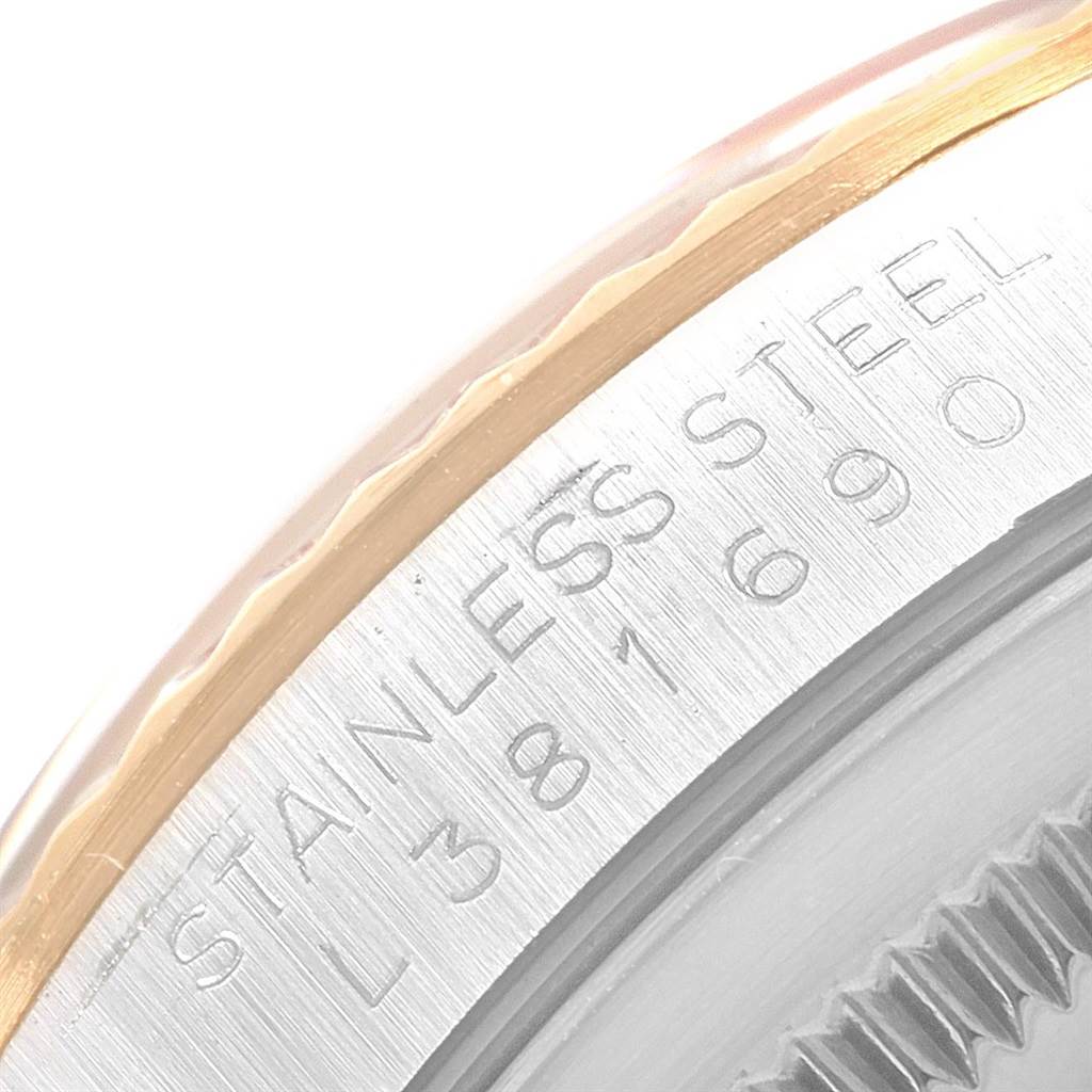 This close-up image of a Rolex Datejust 16233 Men's Steel and Gold (two tone) Black Dial 16233 Men's Steel and Gold (two tone) Black Dial watch shows the stainless steel casing with part of the fluted bezel and engravings.