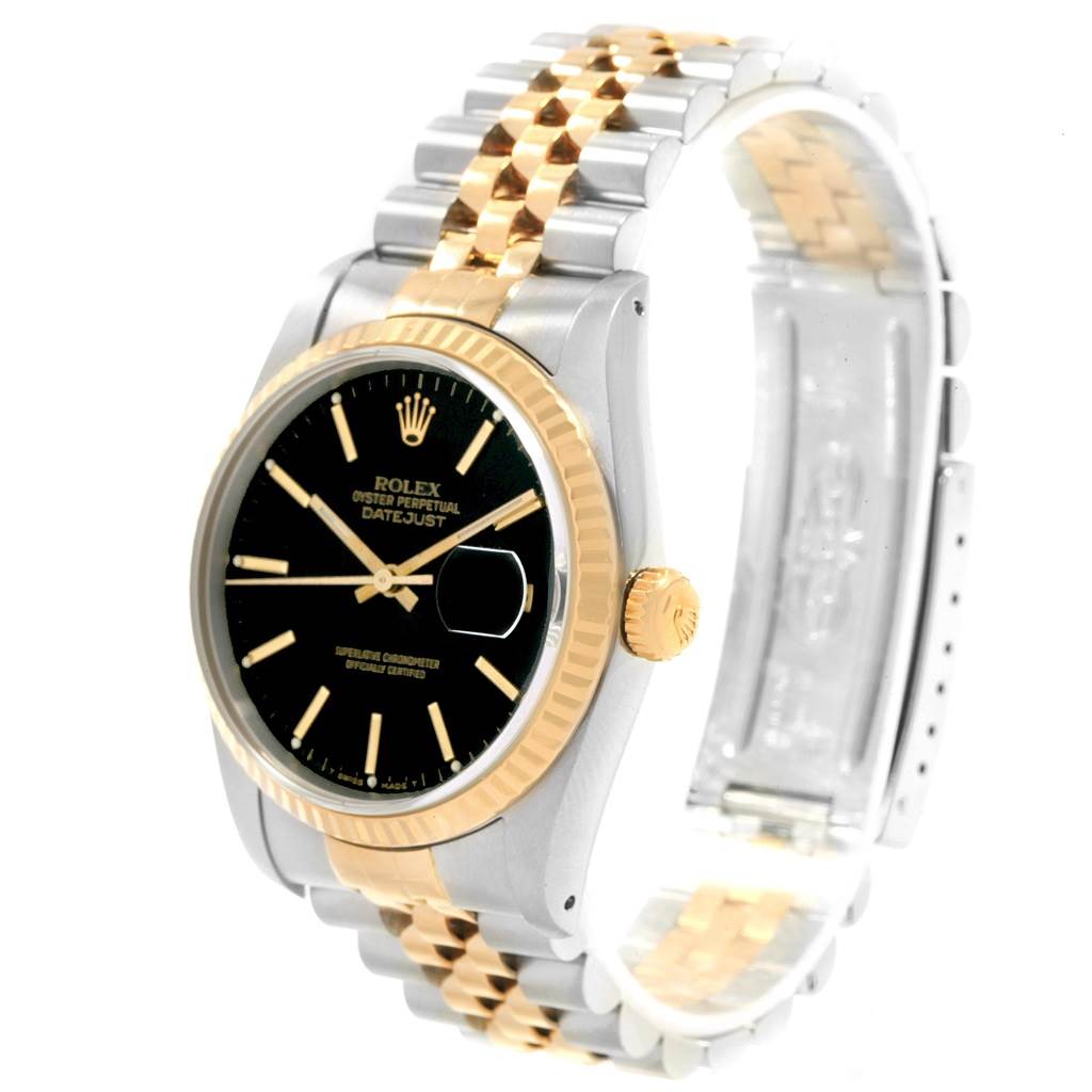 The image shows a Rolex Datejust 16233 Men's Steel and Gold (two tone) Black Dial 16233 Men's Steel and Gold (two tone) Black Dial watch at a slight angle, featuring a black dial, fluted bezel, and two-tone metal bracelet.