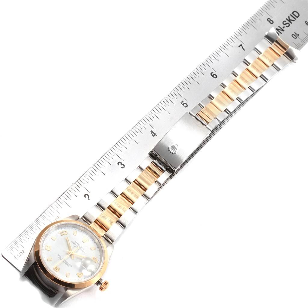 The image shows a Rolex Datejust 15203 Men's Steel and Gold (two tone) White Dial 15203 Men's Steel and Gold (two tone) White Dial watch, including its dial and bracelet, positioned alongside a ruler for measurement.