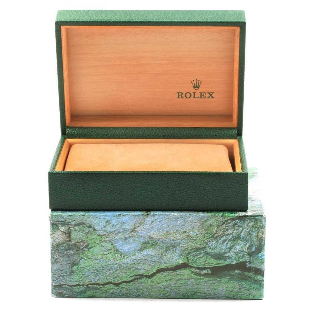 This image shows a green Rolex box for a Datejust model, open with the interior cushion visible.