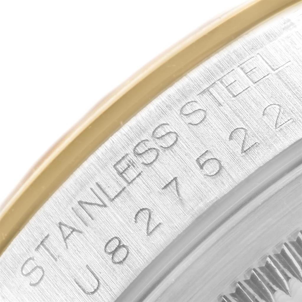 This close-up image shows part of the case and bezel of a Rolex Datejust 16203 Men's Steel and Gold (two tone) Grey Dial 16203 Men's Steel and Gold (two tone) Grey Dial watch, highlighting its stainless steel material and serial number.