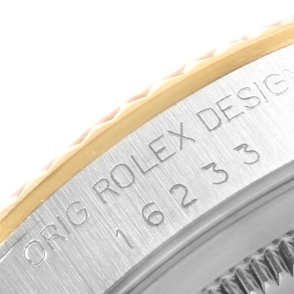This image shows a close-up of the bezel and part of the case of a Rolex Datejust 16233 Men's Steel and Gold (two tone) Champagne Dial 16233 Men's Steel and Gold (two tone) Champagne Dial, revealing engraving details.