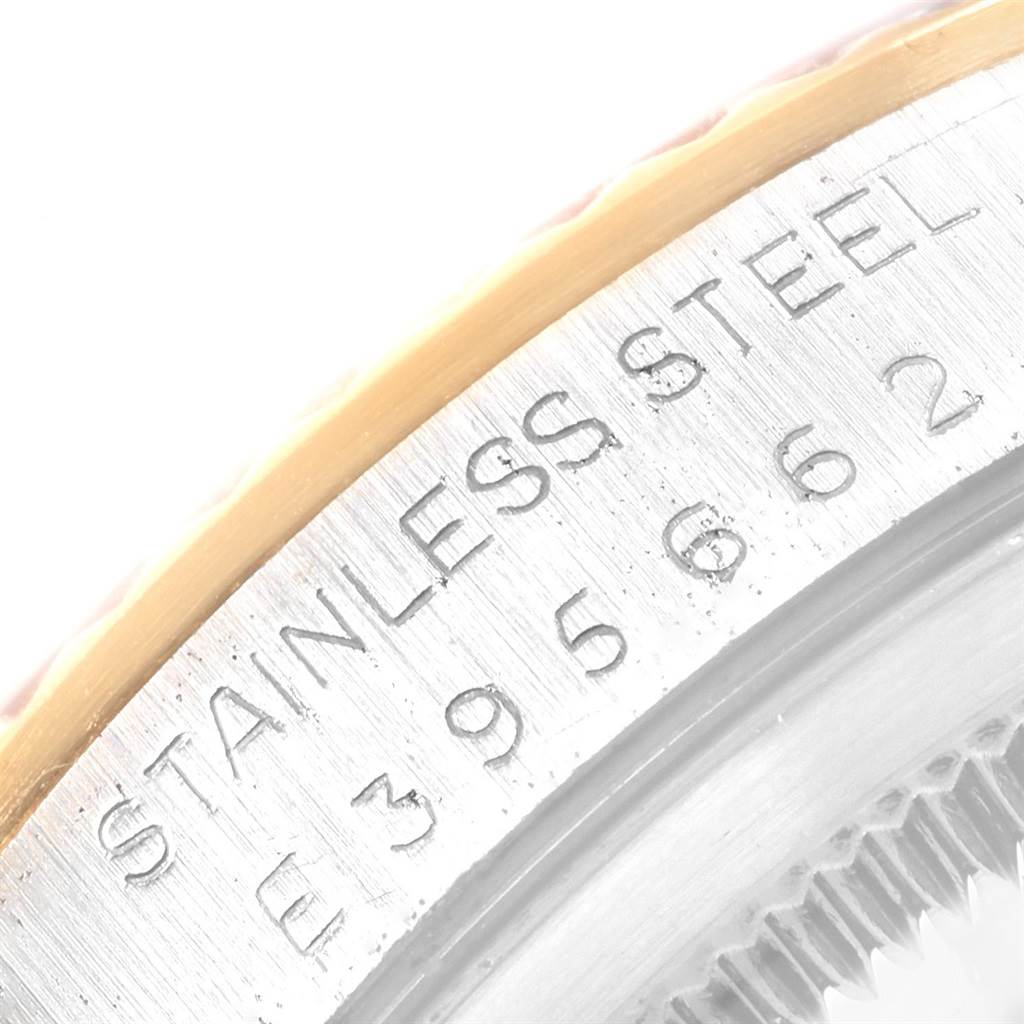 The image shows an angled close-up of the case back and part of the bezel of a Rolex Datejust 16233 Men's Steel and Gold (two tone) Champagne Dial 16233 Men's Steel and Gold (two tone) Champagne Dial watch.