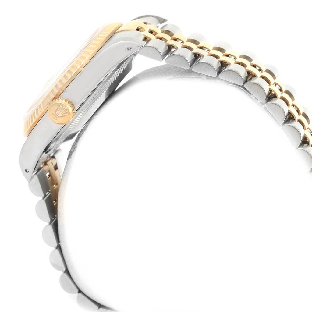 The image shows a side view of a Rolex Datejust 16233 Men's Steel and Gold (two tone) Champagne Dial 16233 Men's Steel and Gold (two tone) Champagne Dial watch, highlighting its crown, case, and part of the two-tone bracelet.