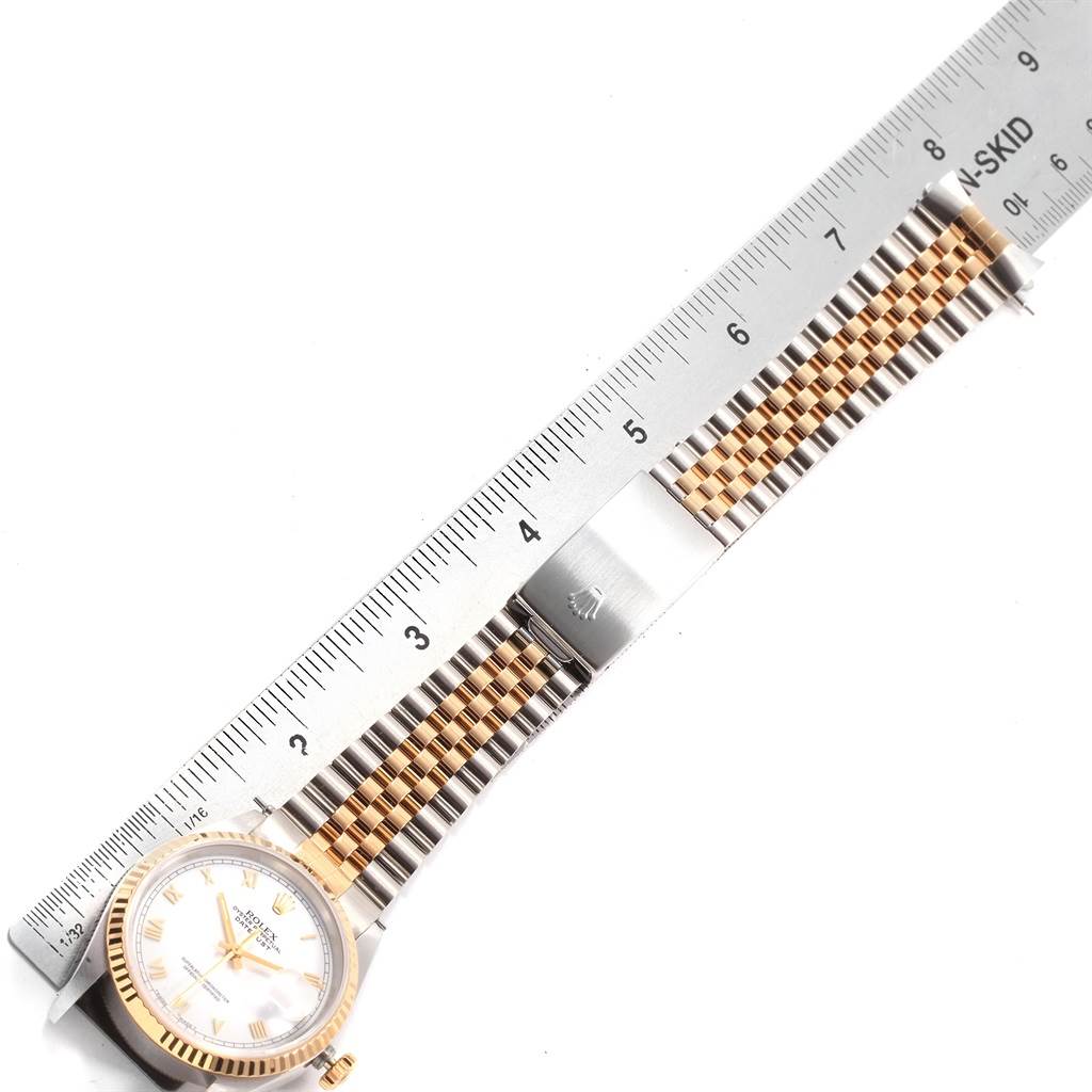 The image shows a Rolex Datejust 16233 Men's Steel and Gold (two tone) White Dial 16233 Men's Steel and Gold (two tone) White Dial watch laid flat with a ruler measuring its bracelet.