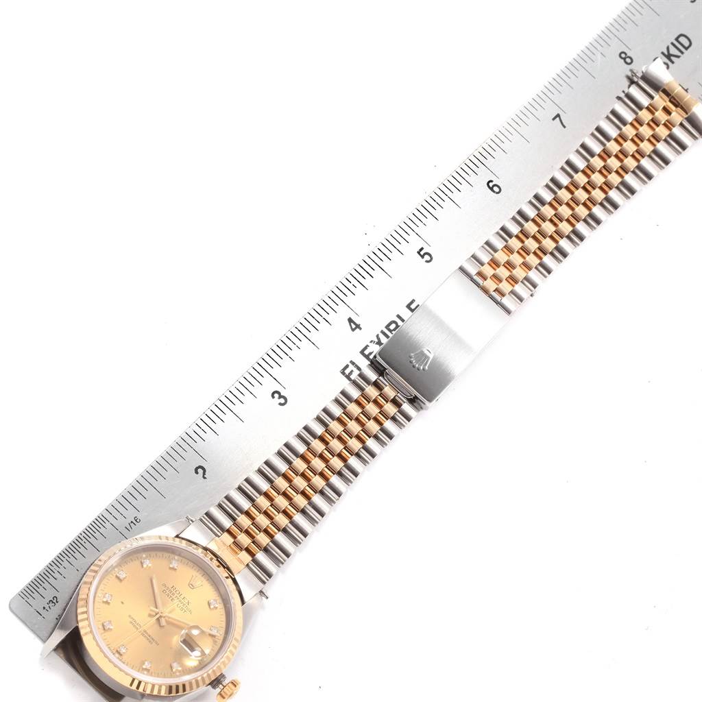The image shows a Rolex Datejust 16233 Men's Steel and Gold (two tone) Champagne Dial 16233 Men's Steel and Gold (two tone) Champagne Dial watch lying flat, with a metal ruler measuring its two-tone bracelet and clasp.