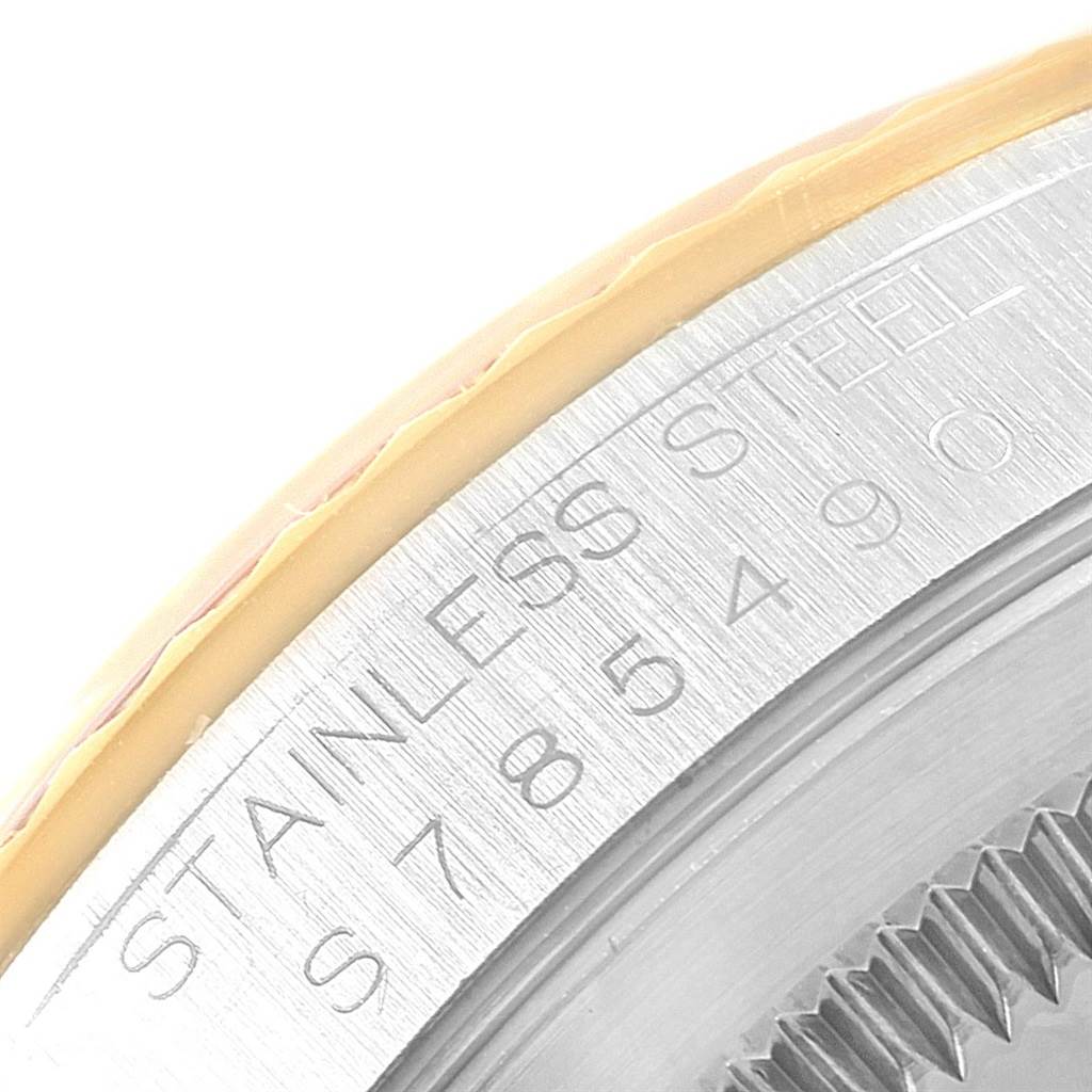 This close-up image shows the engraved stainless steel side of the watch case for the Rolex Datejust 16233 Men's Steel and Gold (two tone) Champagne Dial 16233 Men's Steel and Gold (two tone) Champagne Dial model.