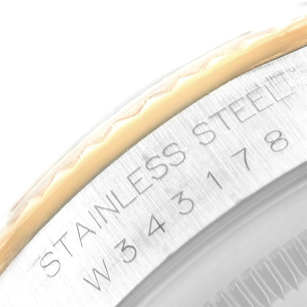 The image shows a close-up view of the stainless steel bezel and engraving on a Datejust model by Rolex.