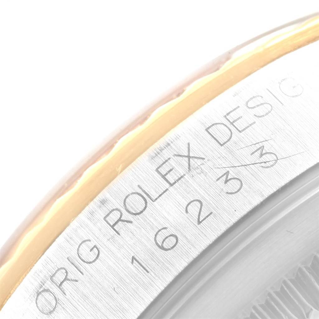 This image shows a close-up of the bezel and engraved details on a Rolex Datejust 16233 Men's Steel and Gold (two tone) Black Dial 16233 Men's Steel and Gold (two tone) Black Dial watch.
