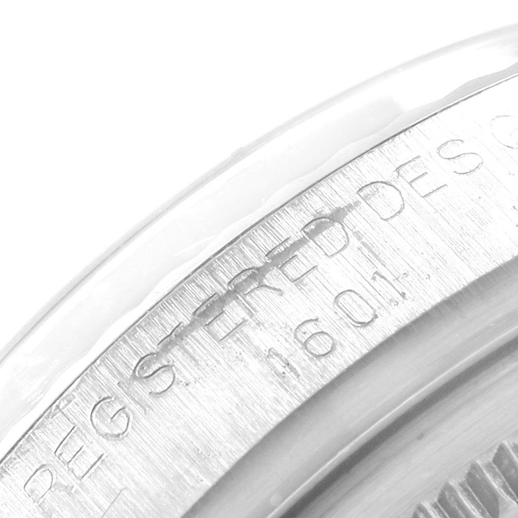The image shows a close-up of the engraved side case and bezel of a Rolex Datejust 1601 Men
s Stainless Steel Silver Dial 1601 Men
s Stainless Steel Silver Dial watch displaying the model number.