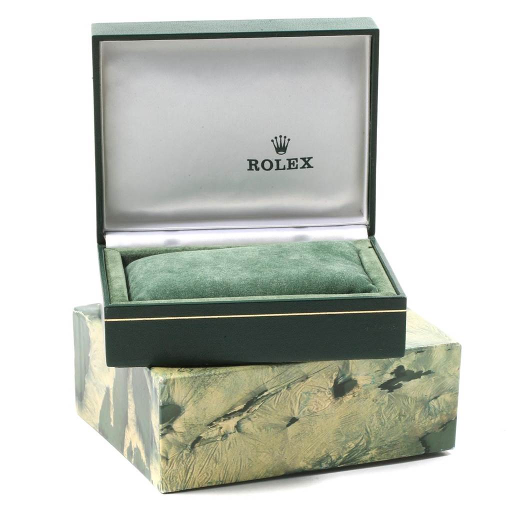 The image shows an open Rolex Datejust 1601 Men
s Stainless Steel Silver Dial 1601 Men
s Stainless Steel Silver Dial watch box with a green cushion inside.