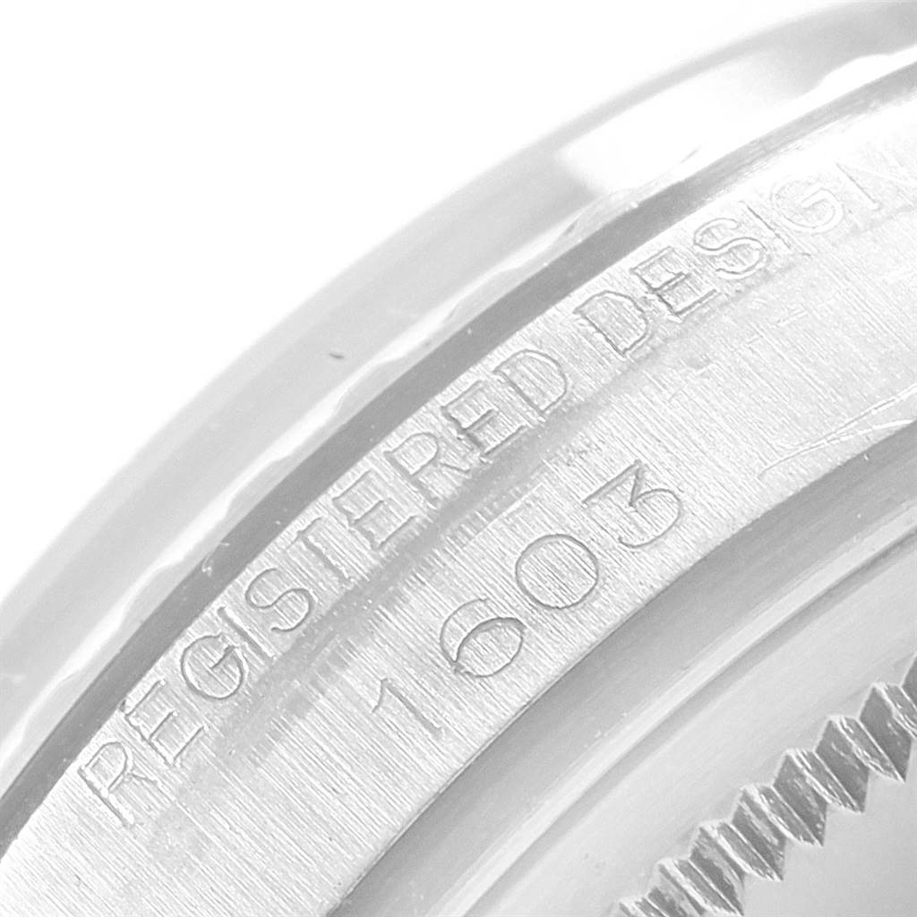 The image shows a close-up of the engraving on the side of the case back of a Rolex Datejust 1601 Men
s Stainless Steel Silver Dial 1601 Men
s Stainless Steel Silver Dial model.