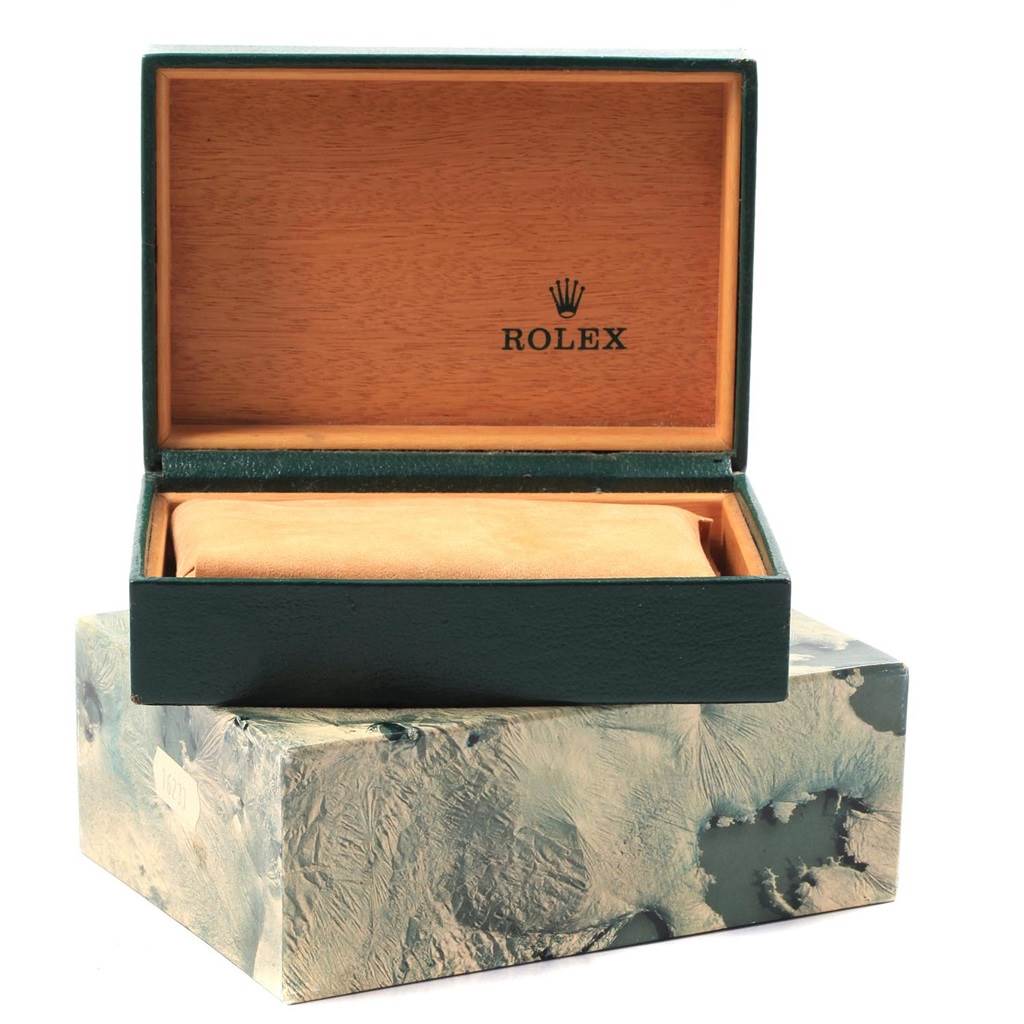 The image shows an open Rolex Datejust 1601 Men
s Stainless Steel Silver Dial 1601 Men
s Stainless Steel Silver Dial watch box with a watch cushion inside.