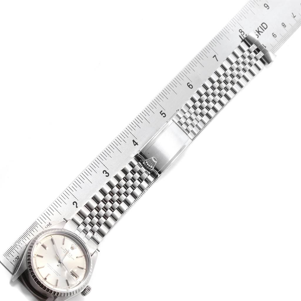 The image shows a Rolex Datejust 1601 Men
s Stainless Steel Silver Dial 1601 Men
s Stainless Steel Silver Dial watch laid flat with its bracelet extended and a ruler for scale.