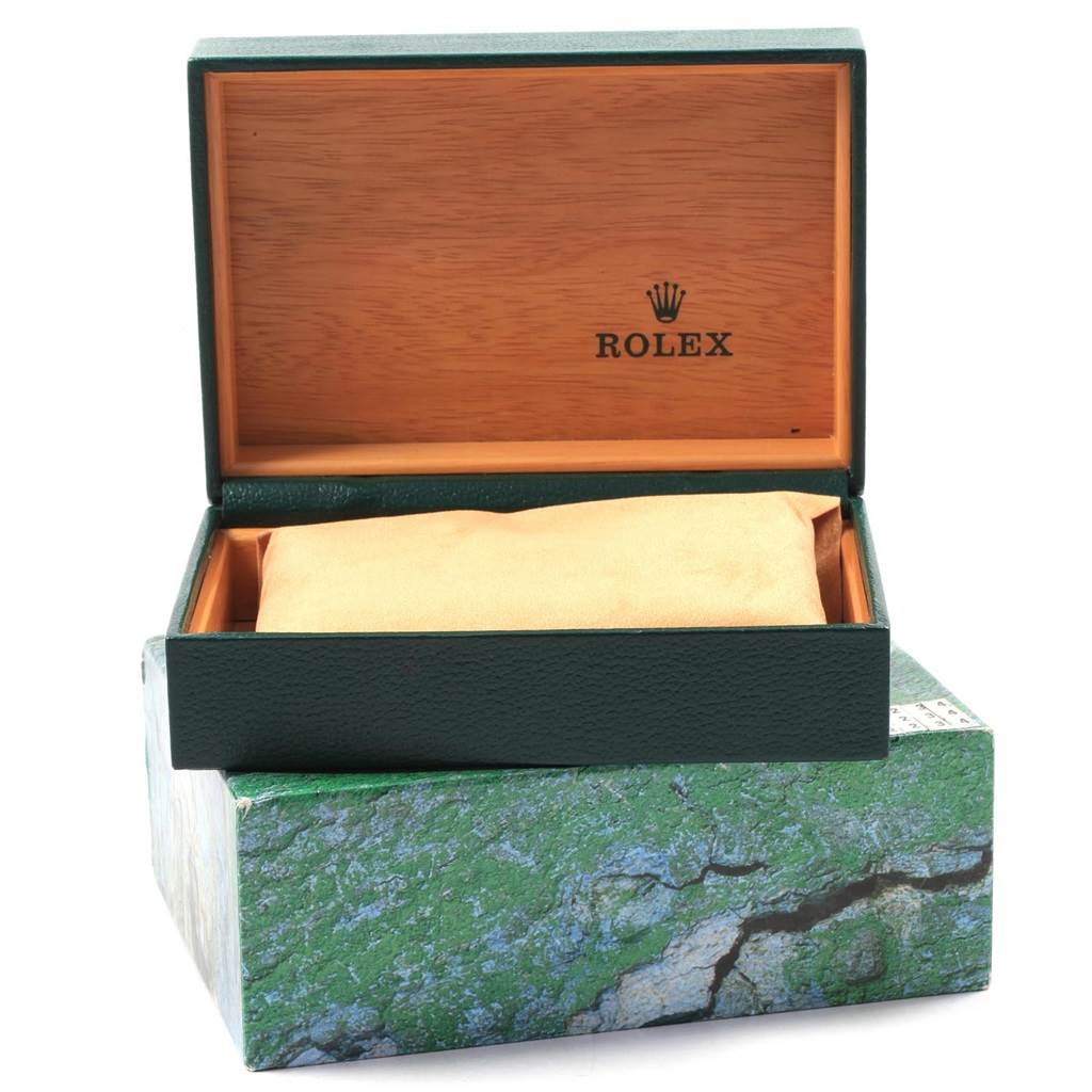 This image shows the open green Rolex Datejust 16234 Men
s Stainless Steel Blue Dial 16234 Men
s Stainless Steel Blue Dial watch box with a wooden interior, branded logo, and a cushion inside.