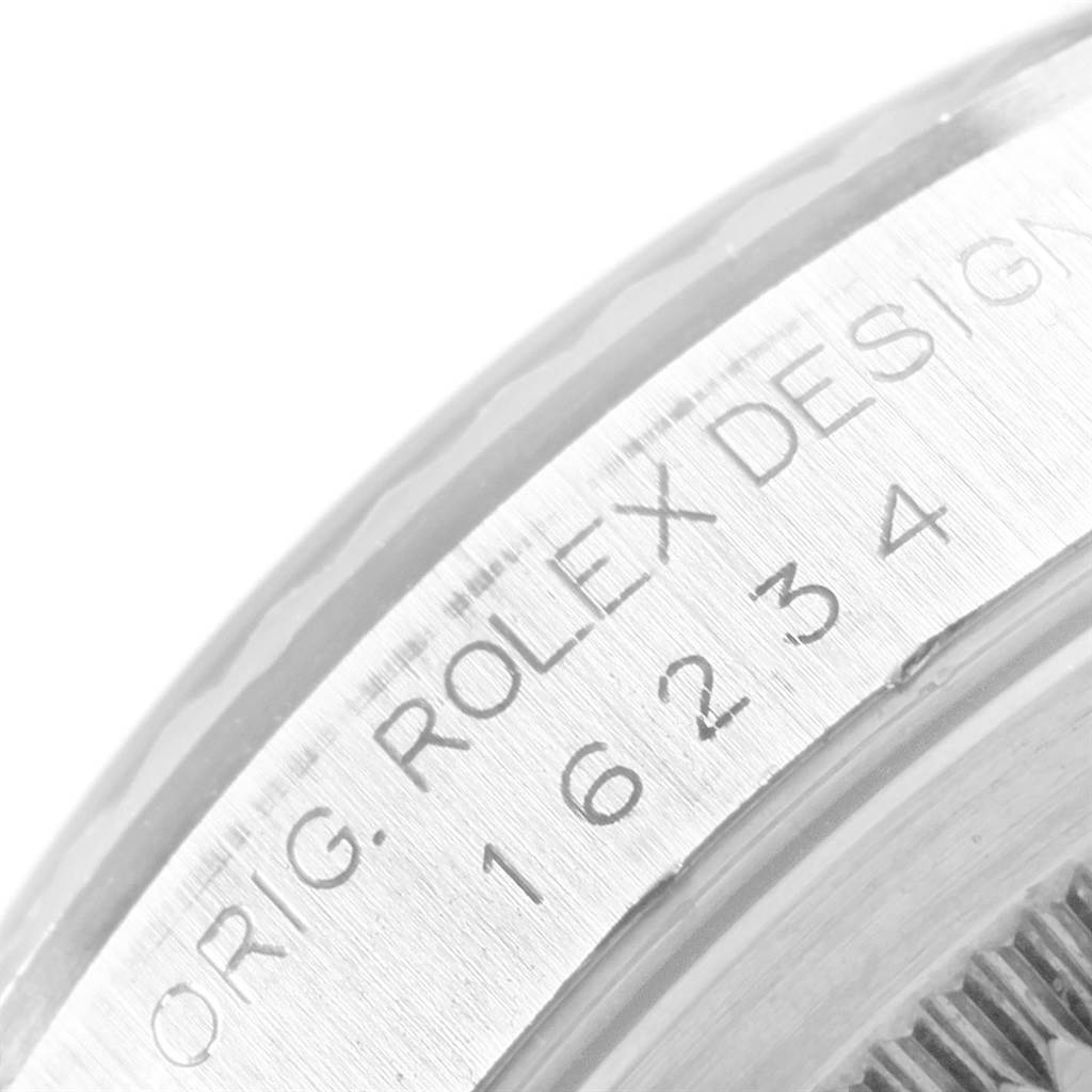 This close-up image shows the side of the bezel and engraved model number of a Rolex Datejust 16234 Men
s Stainless Steel Blue Dial 16234 Men
s Stainless Steel Blue Dial watch.