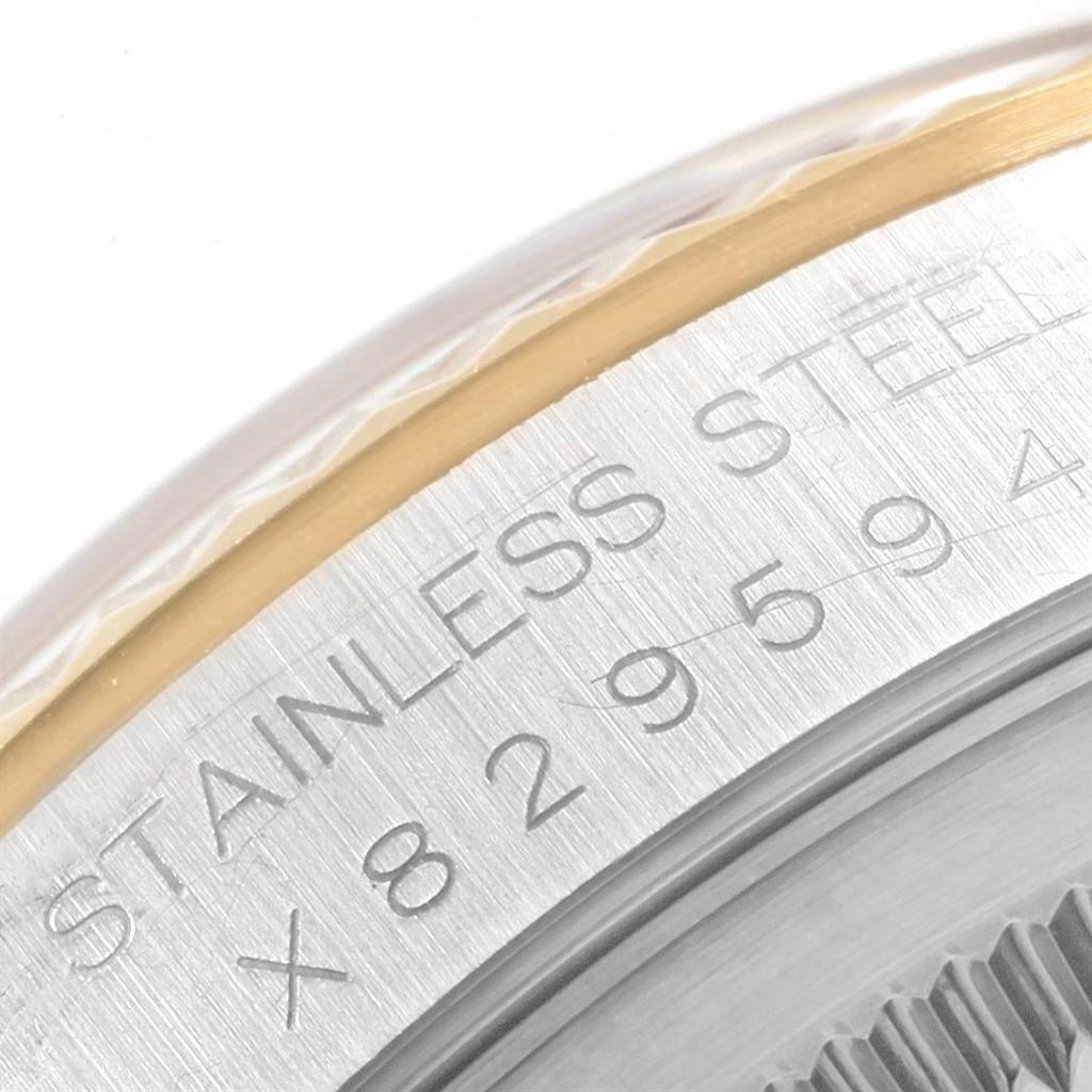 This image shows a close-up of the serial number engraved on the stainless steel case back of a Rolex Datejust 16233 Men's Steel and Gold (two tone) White Dial 16233 Men's Steel and Gold (two tone) White Dial watch.