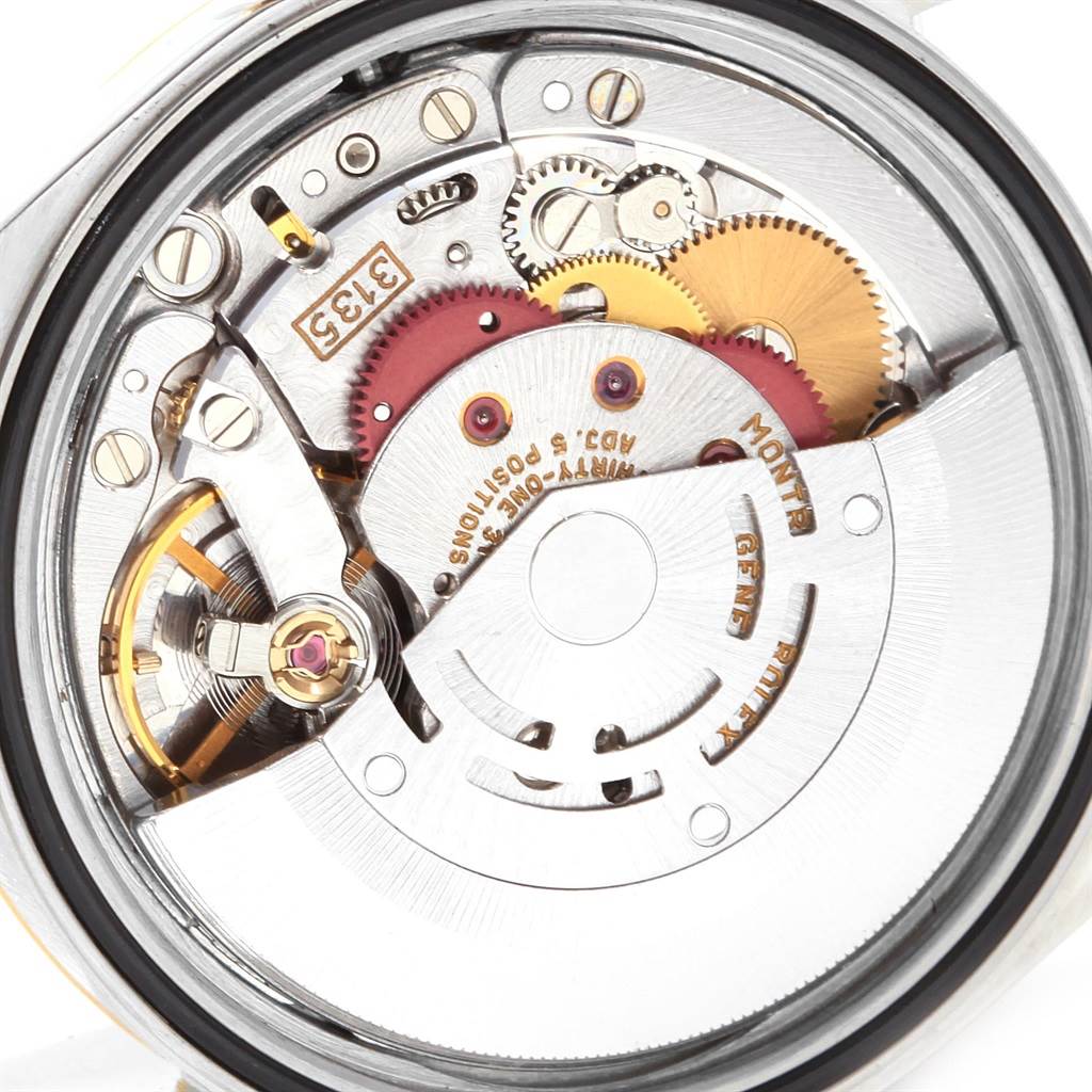 This image shows a close-up inside view of the Rolex Datejust 16233 Men's Steel and Gold (two tone) Champagne Dial 16233 Men's Steel and Gold (two tone) Champagne Dial watch, highlighting its intricate movement and gears.