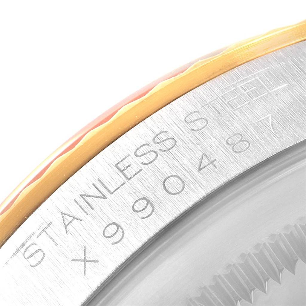 This is a close-up image showing the serial number and stainless steel bezel of a Rolex Datejust 16233 Men's Steel and Gold (two tone) Champagne Dial 16233 Men's Steel and Gold (two tone) Champagne Dial watch.