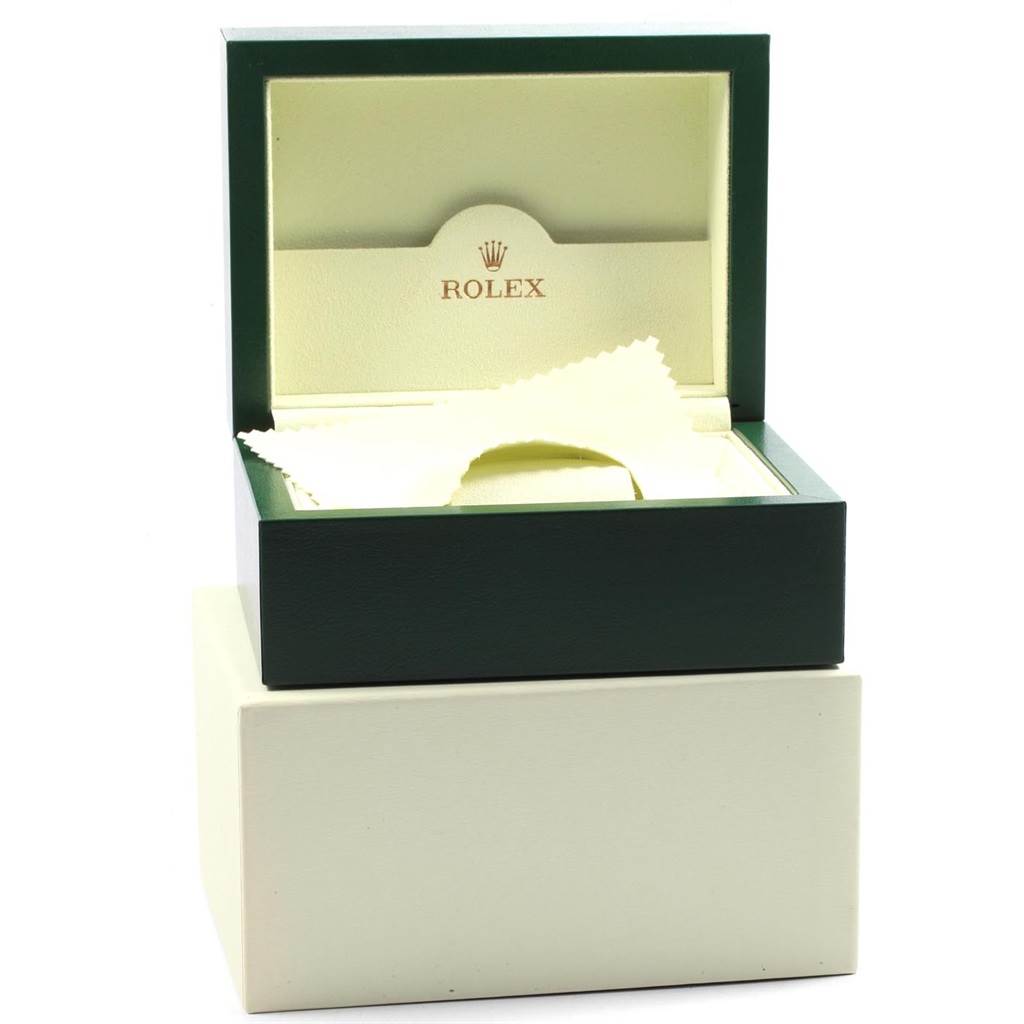 This image shows an open Rolex watch box for a Datejust model, revealing the inner packaging and a cleaning cloth.
