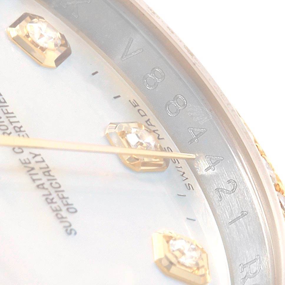 This close-up image of a Rolex Datejust 116243 Men's Stainless Steel Silver Dial 116243 Men's Stainless Steel Silver Dial watch shows the dial with diamond hour markers, gold hands, and parts of the engravings and index marks.