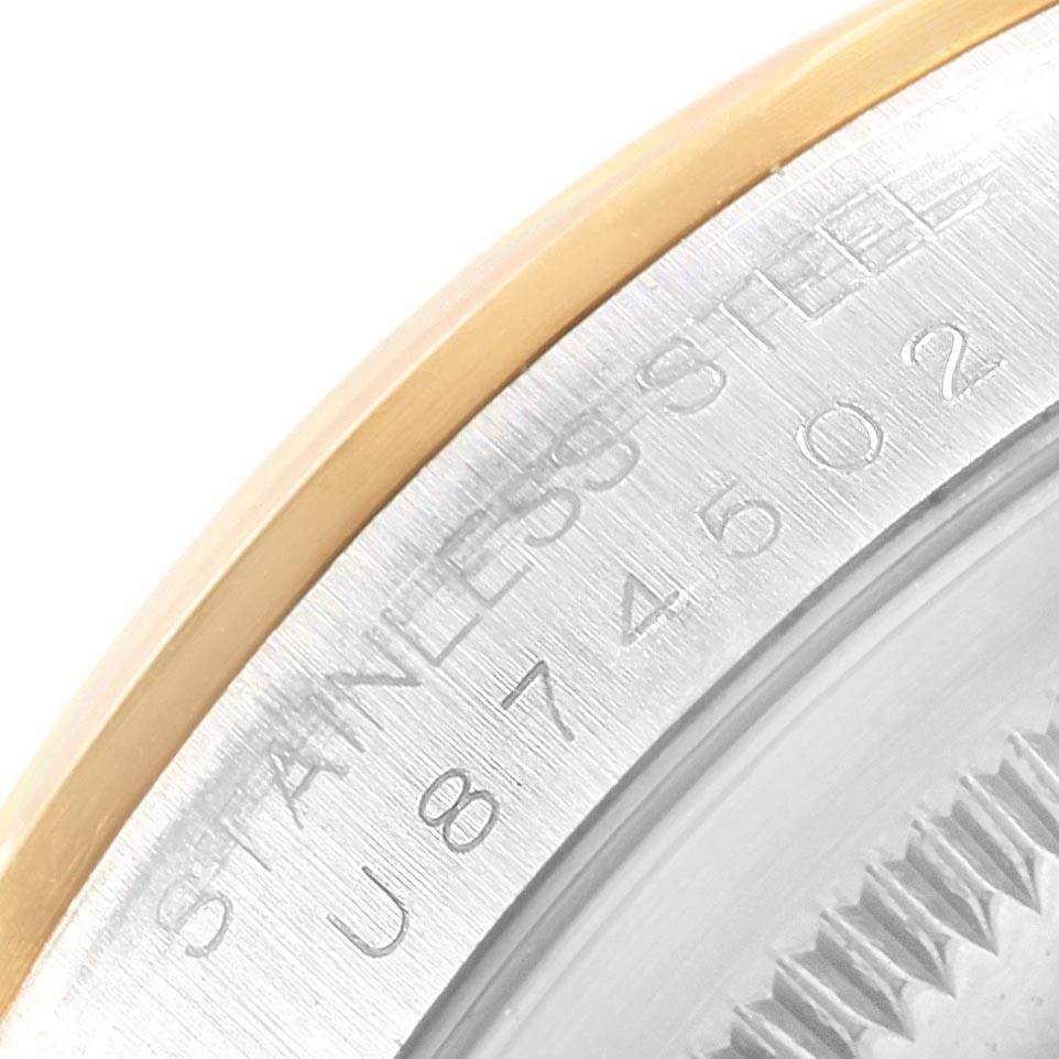 The image shows a close-up of the Rolex Datejust 16203 Men's Steel and Gold (two tone) Champagne Dial 16203 Men's Steel and Gold (two tone) Champagne Dial's stainless steel case with its serial number engraved.