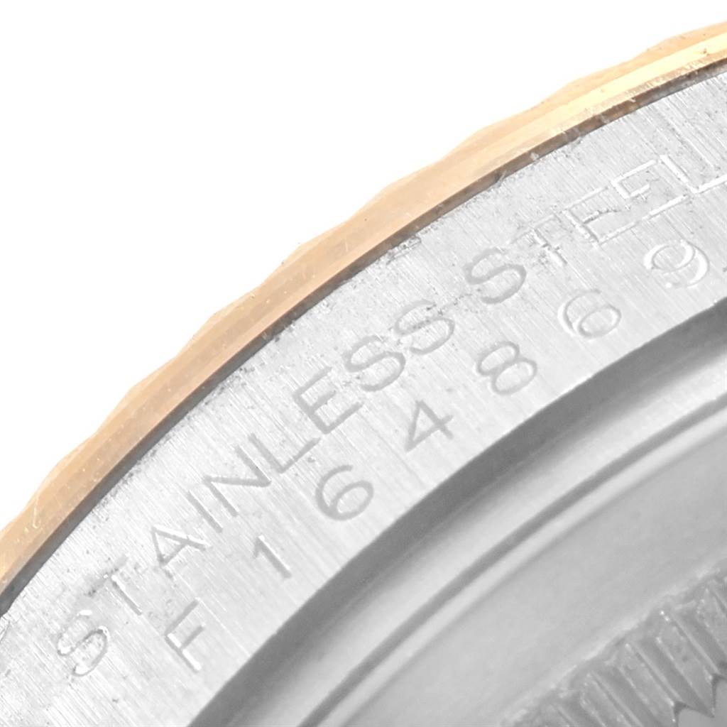 The photo shows a close-up of the outer edge and engraving on the case back of a Rolex Datejust 116233 Men's Stainless Steel Black Dial 116233 Men's Stainless Steel Black Dial watch.