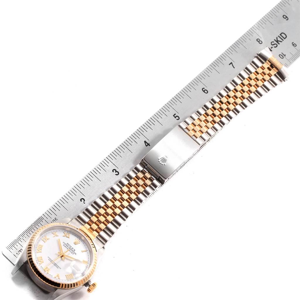 The image shows a Rolex Datejust 16233 Men
s Steel and Gold (two tone) White Dial 16233 Men
s Steel and Gold (two tone) White Dial watch front view, displaying the watch face, bezel, and bracelet with a ruler for scale.