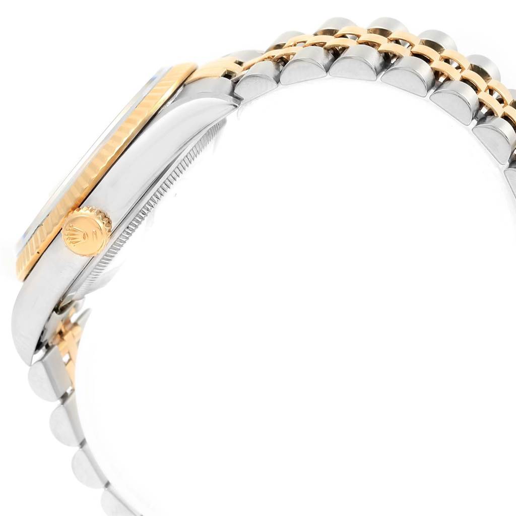 The image shows a side view of a Rolex Datejust 16233 Men
s Steel and Gold (two tone) White Dial 16233 Men
s Steel and Gold (two tone) White Dial watch, highlighting the crown, case, and part of the two-tone bracelet.