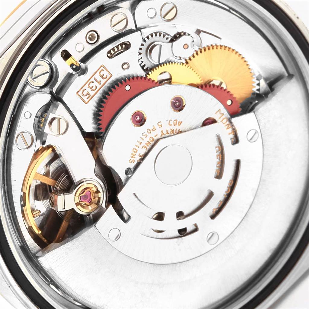 The image shows a close-up view of the intricate movement and internal components of a Rolex Datejust 16233 Men's Steel and Gold (two tone) Beige Dial 16233 Men's Steel and Gold (two tone) Beige Dial watch.