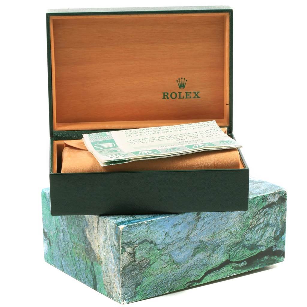 This image shows the packaging for a Rolex Datejust 16233 Men's Steel and Gold (two tone) Beige Dial 16233 Men's Steel and Gold (two tone) Beige Dial watch, with a green and brown box, and accompanying papers.