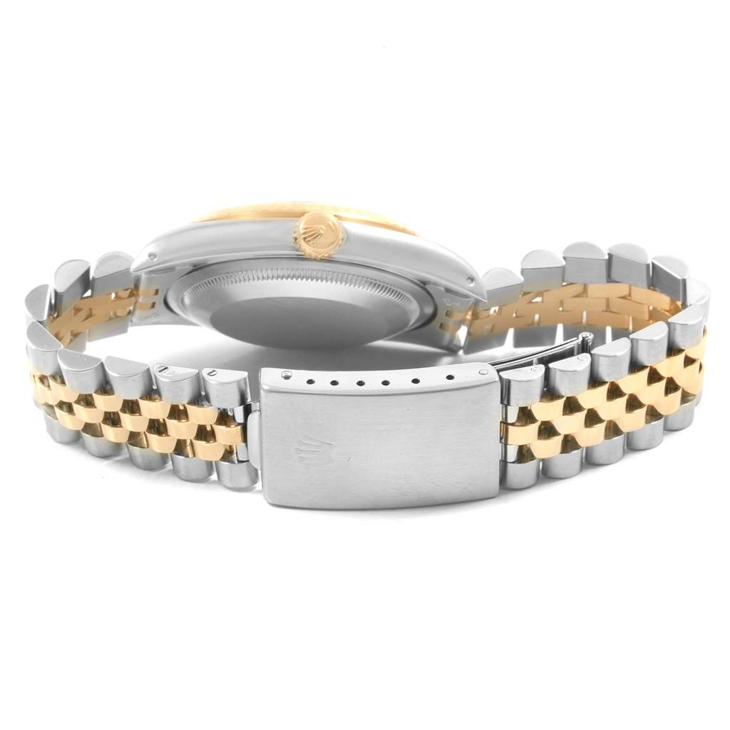 The image shows the underside and side view of the Rolex Datejust 16233 Men's Steel and Gold (two tone) Beige Dial 16233 Men's Steel and Gold (two tone) Beige Dial watch, highlighting its clasp and two-tone bracelet.