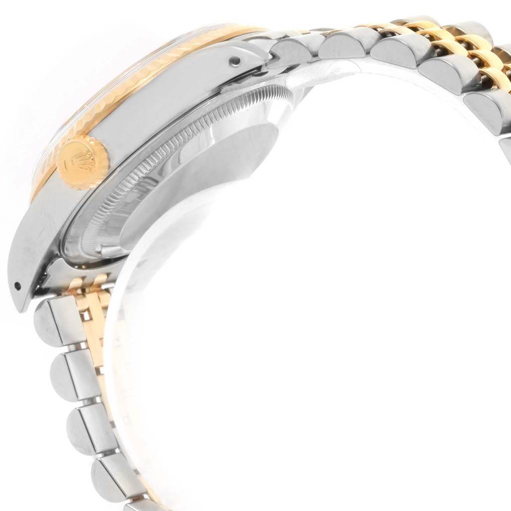 This side view of the Rolex Datejust 16233 Men's Steel and Gold (two tone) Beige Dial 16233 Men's Steel and Gold (two tone) Beige Dial watch shows the case, crown, and part of the Jubilee bracelet.