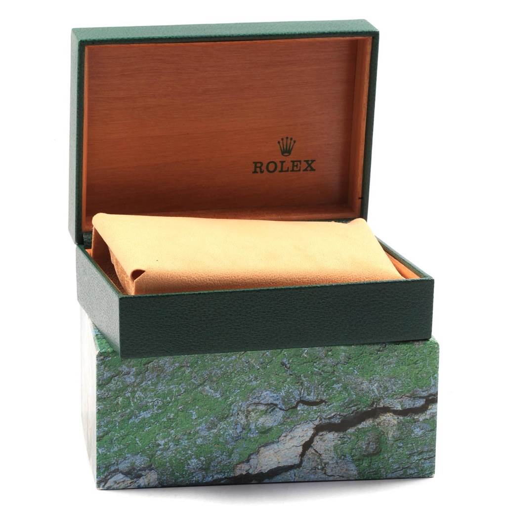 The image shows an open green and wooden Rolex box for the Datejust model with a beige cushioning pillow inside.